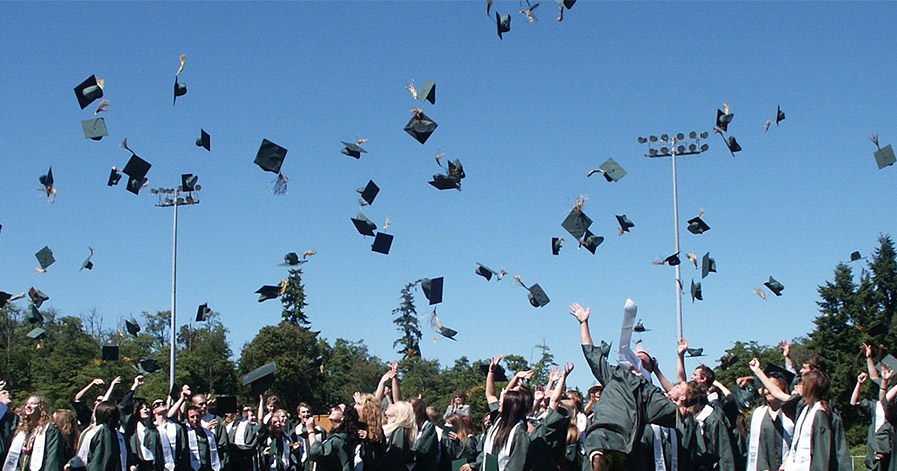 Graduates throwing hats in the air