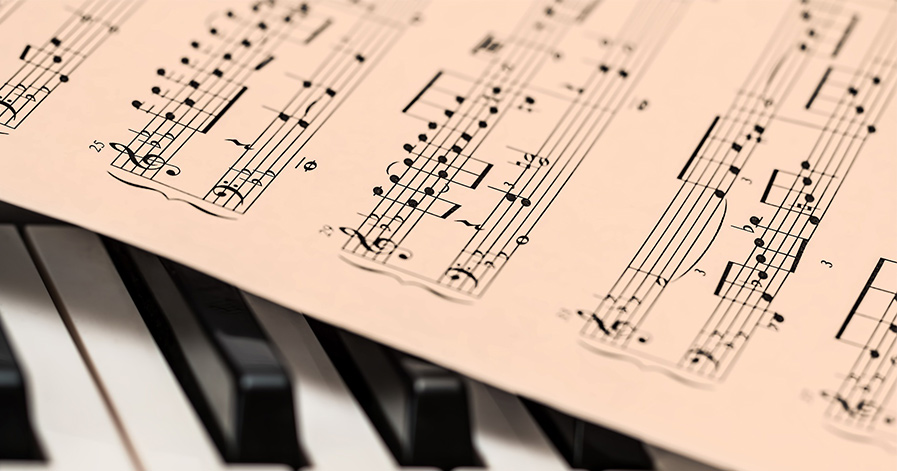Music sheets over piano keys
