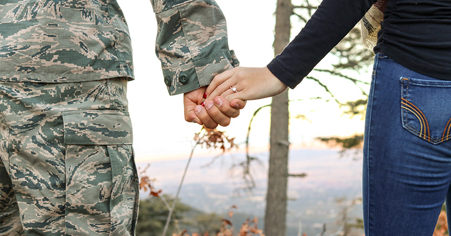 man in uniform holding hand of woman