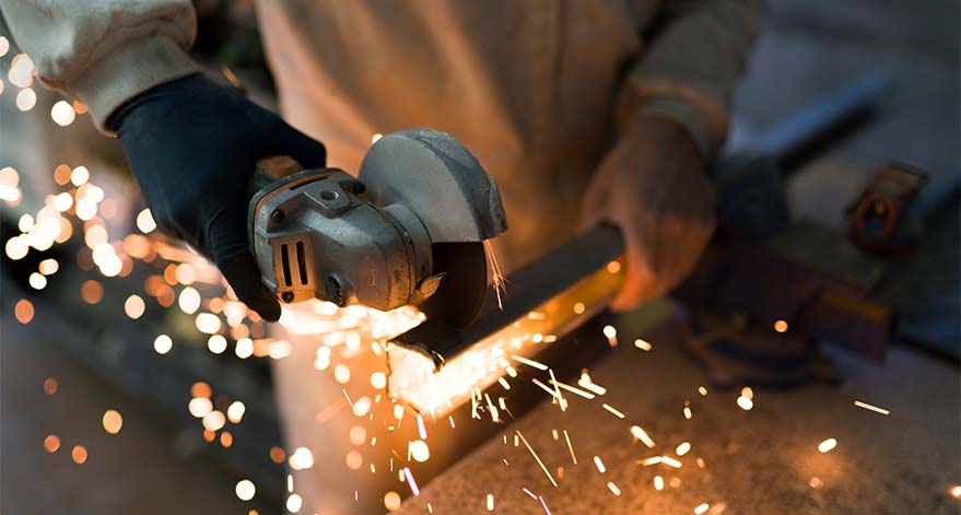A welder cutting metal.